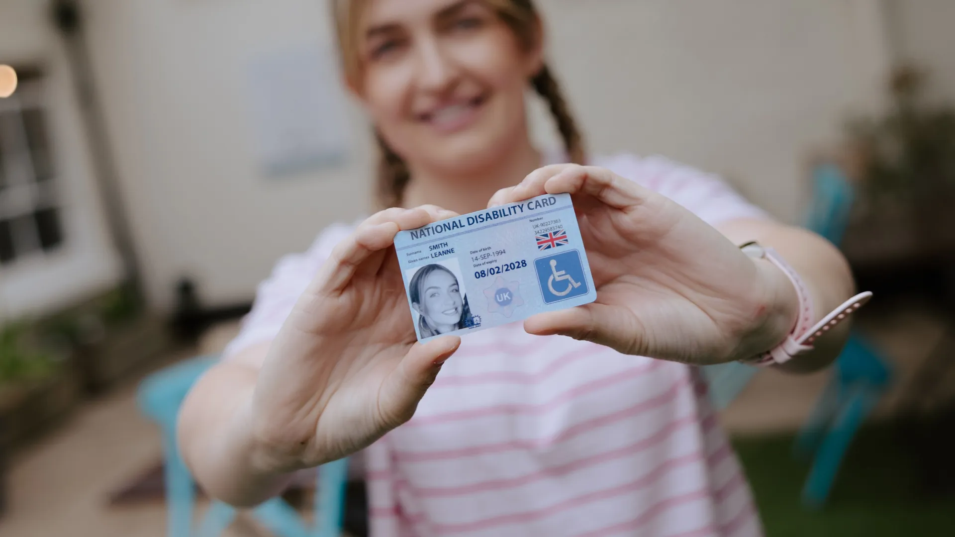 national disability card holder showing her card at a venue for carer ticket access