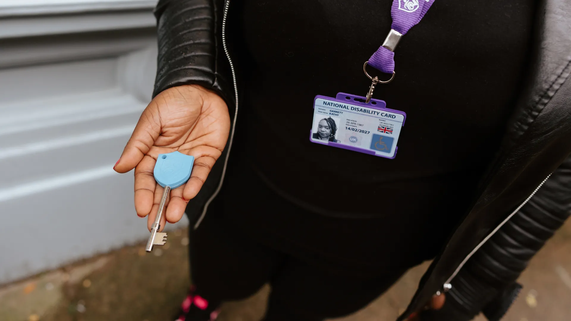national disability card holder showing her card at a venue for carer ticket access