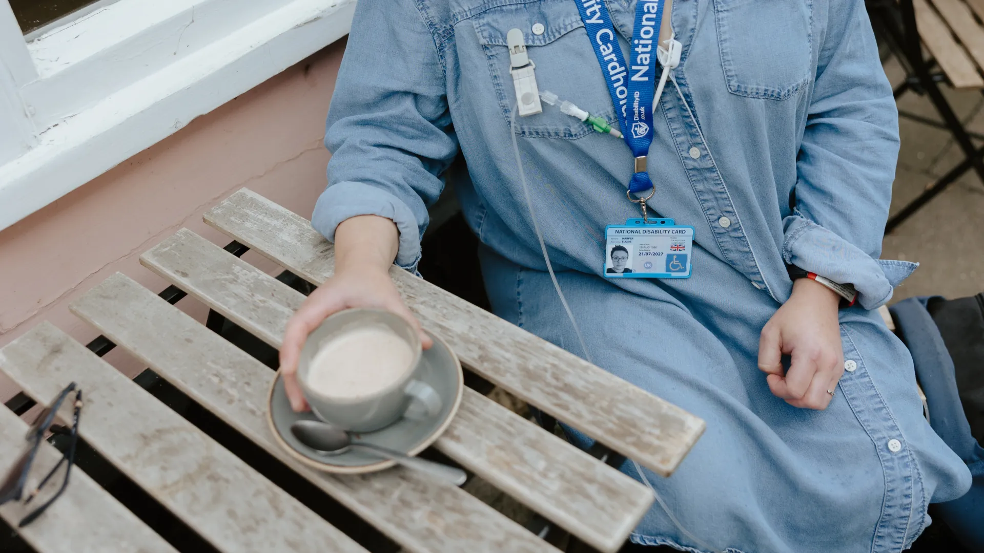 national disability card holder showing her card at a venue for carer ticket access
