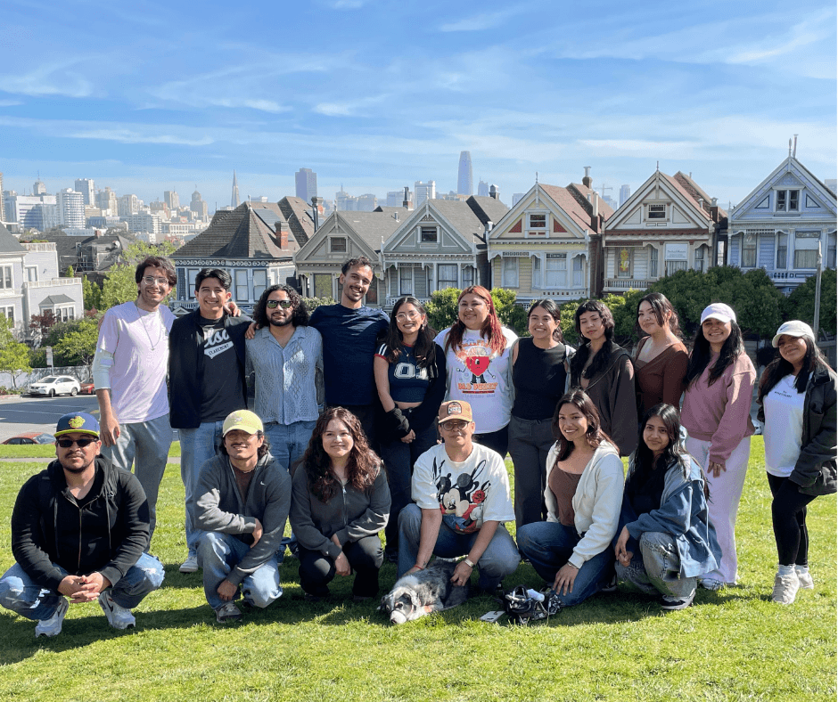 DreamSF fellows posing together outdoors in San Francisco with the Painted Ladies in the background.