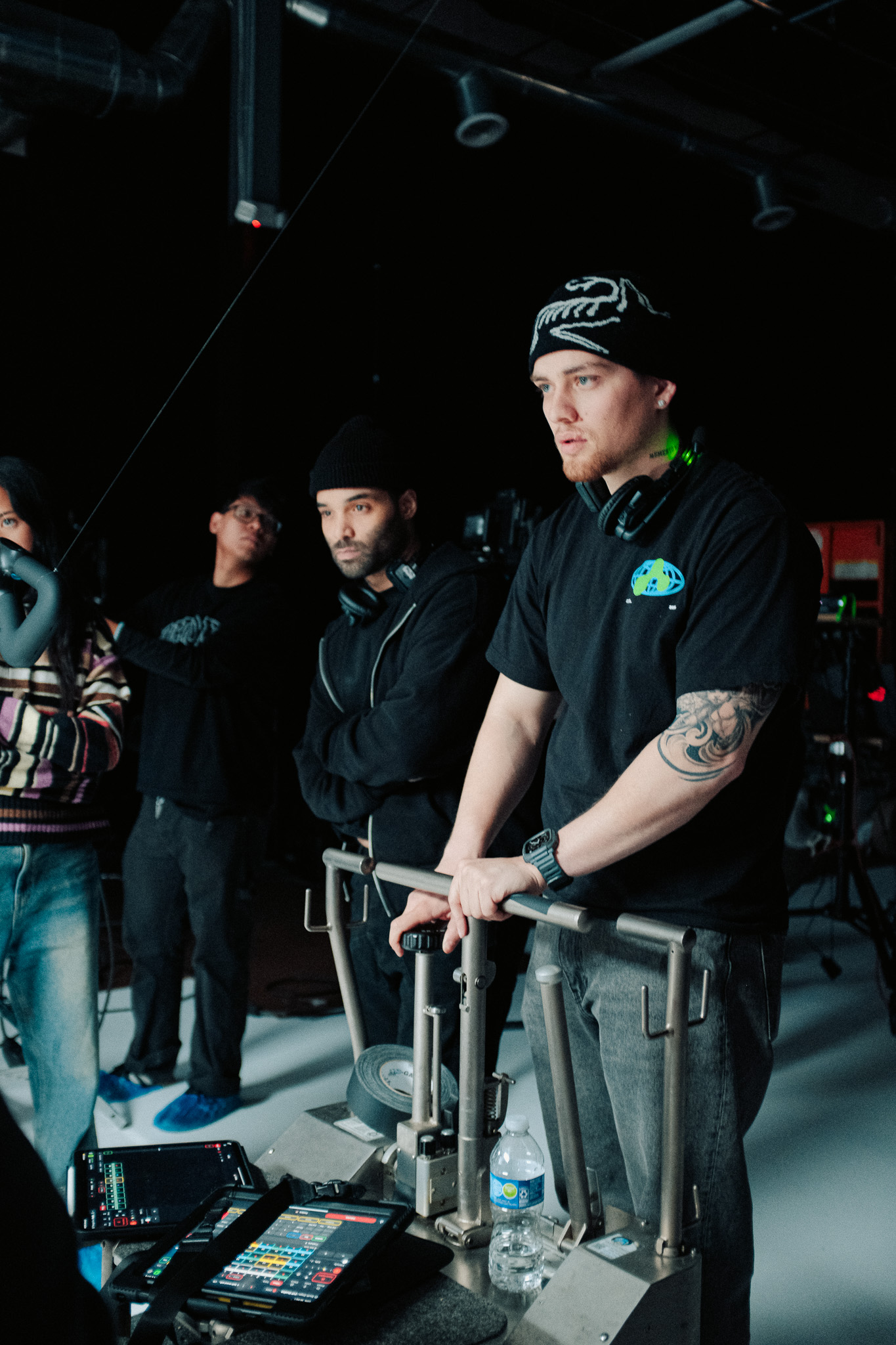 Dolly grip and crew watching a take from behind the dolly