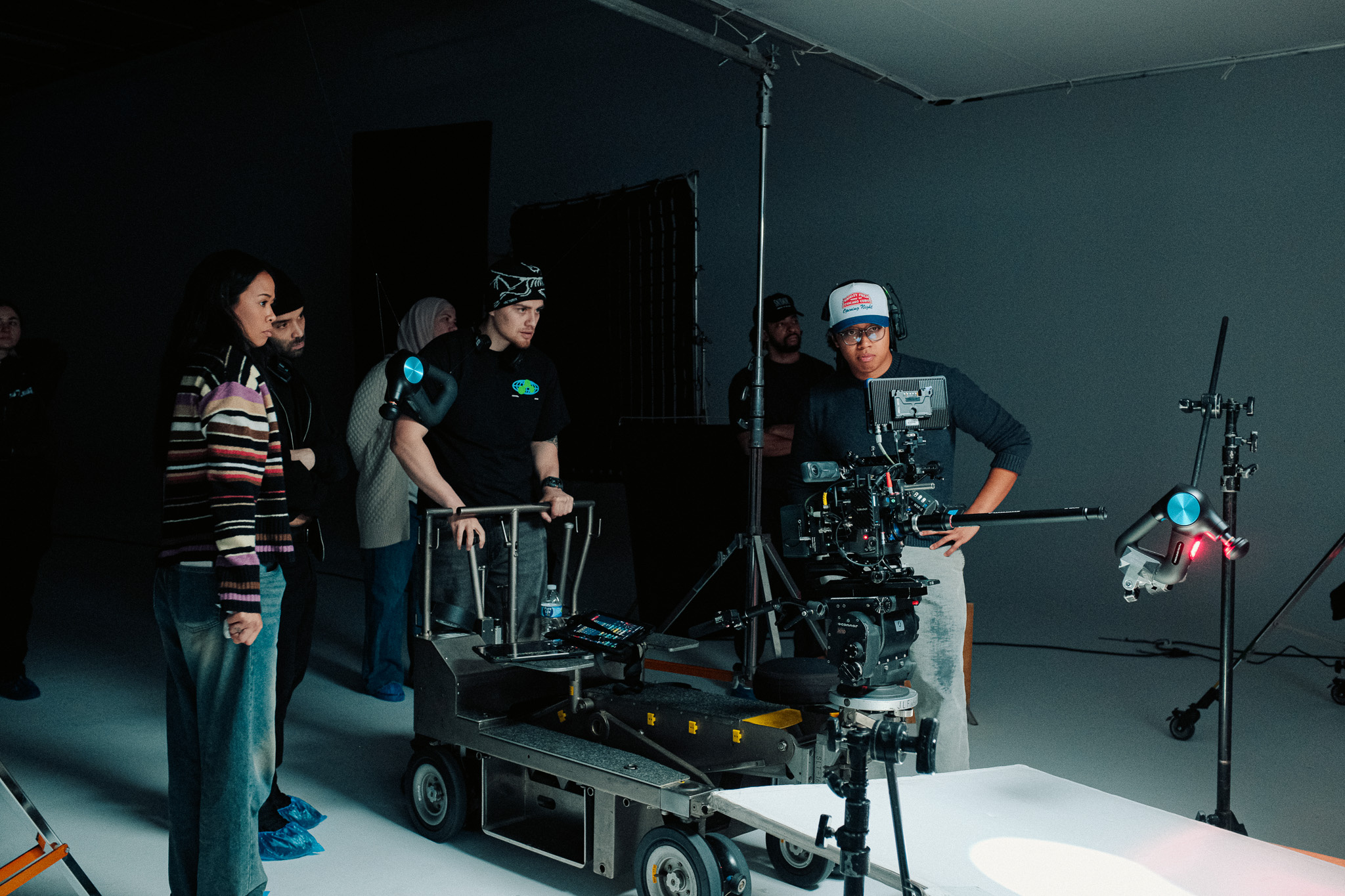 Crew gathered at the dolly watching the Theragun product setup
