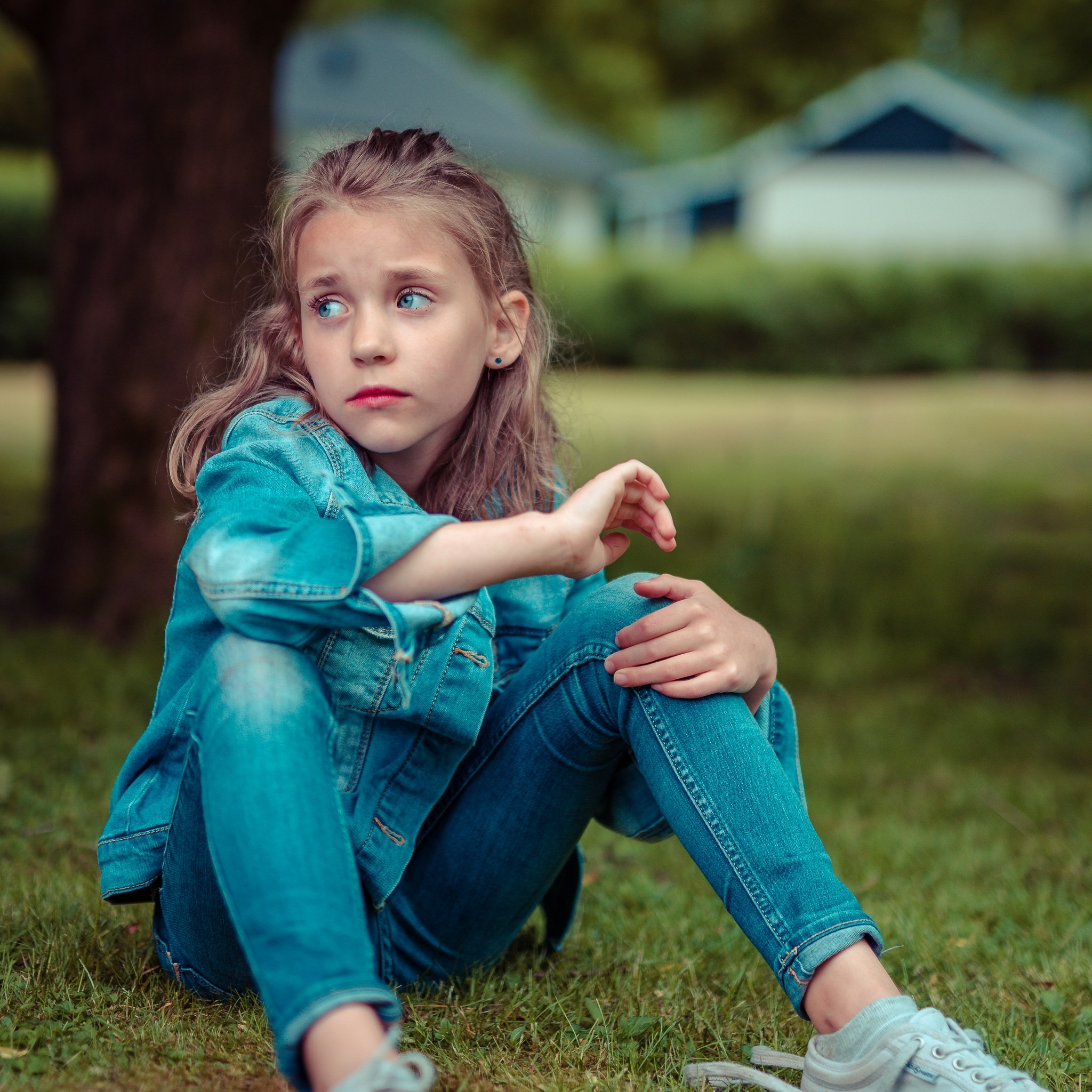 Young child sitting alone outdoors, reflecting the emotional loneliness adult children of narcissists may carry into adulthood.