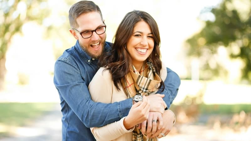 A socially intelligent man cuddling a woman
