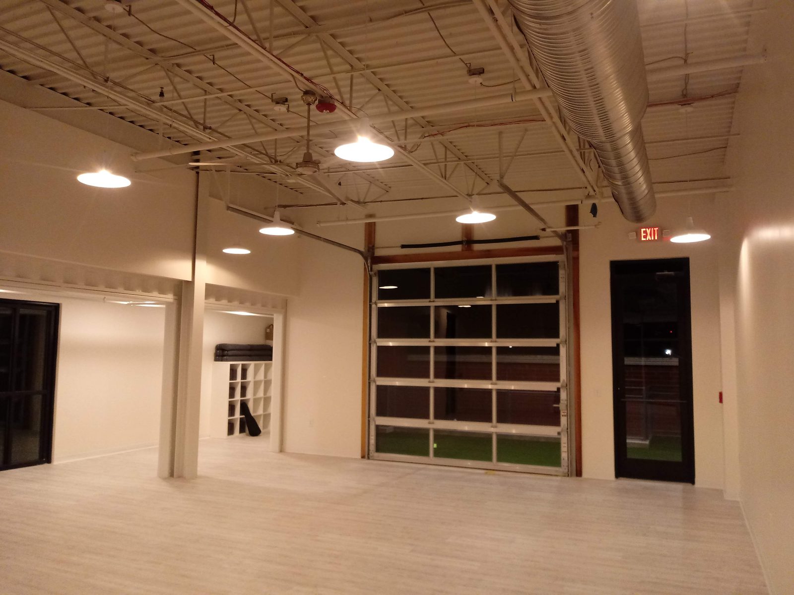 Commercial interior with glass roll-up door and newly painted walls