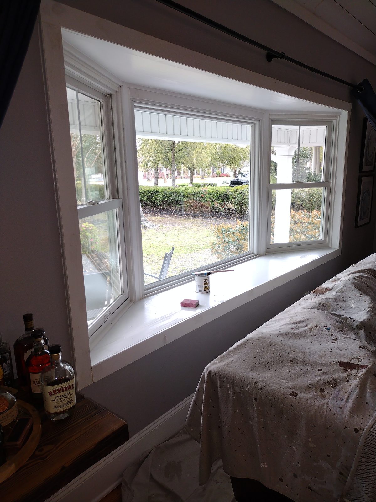 Bay window with repainted white trim and sill during interior renovation