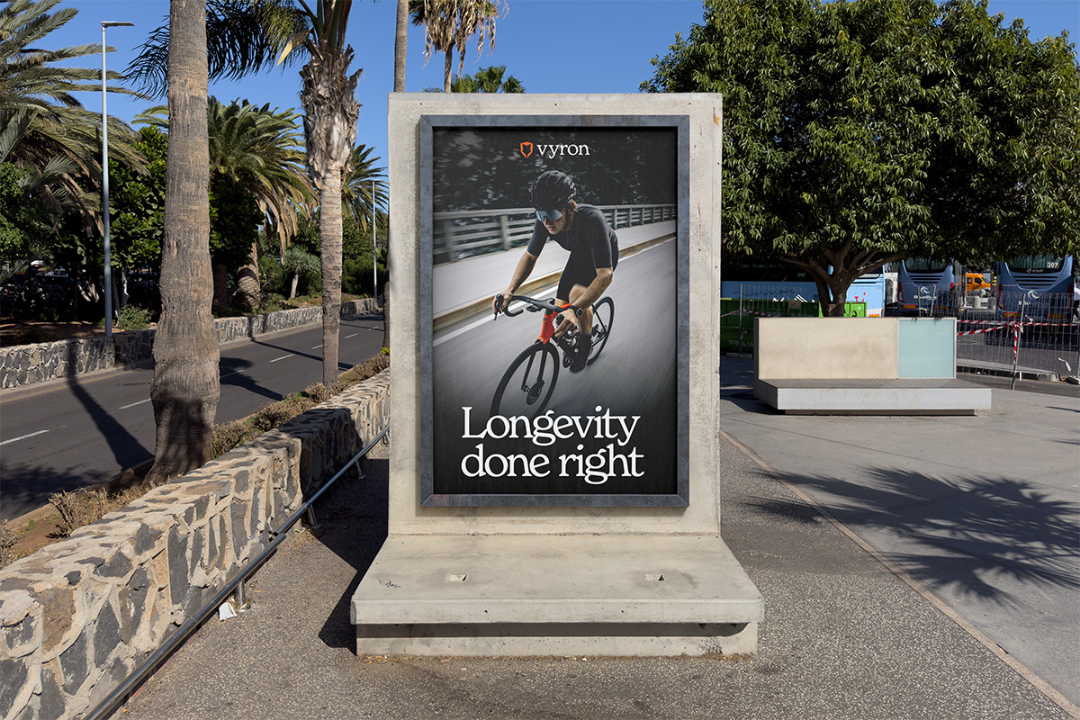 Vyron outdoor poster featuring a cyclist with the line “Longevity done right”