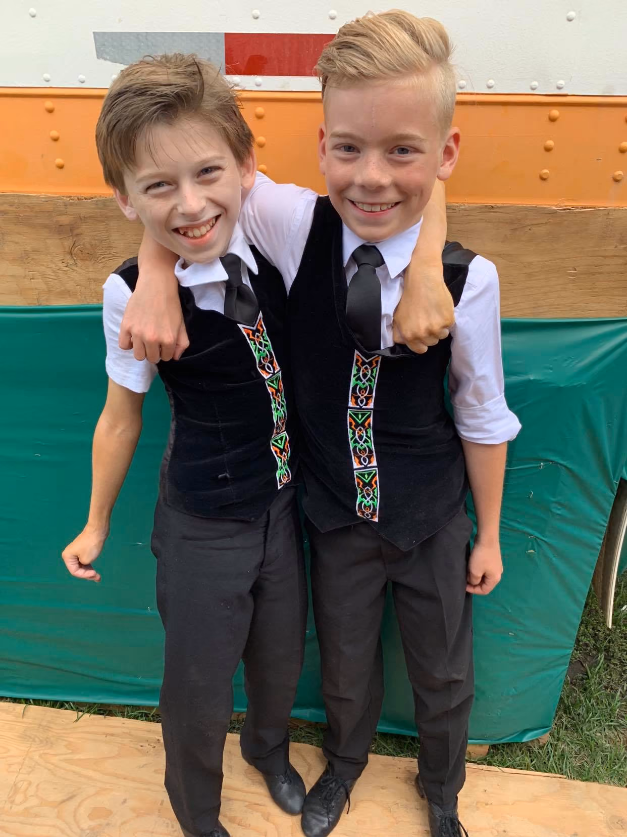 Two boys who dance at Mattierin smiling side stage at the Servus Heritage Days Festival in Edmonton, AB