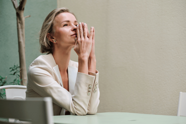 woman us executive thinking with a smile in her face