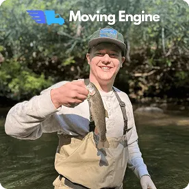 Pierce Jemison, Marketing & Branding lead at BC Brothers Moving, pointing at company branding