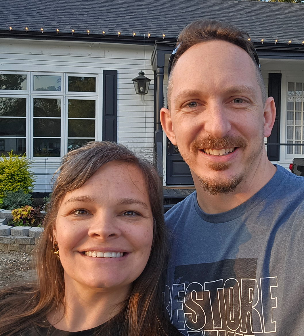 Mark and his wife Misty smiling together in the mountains