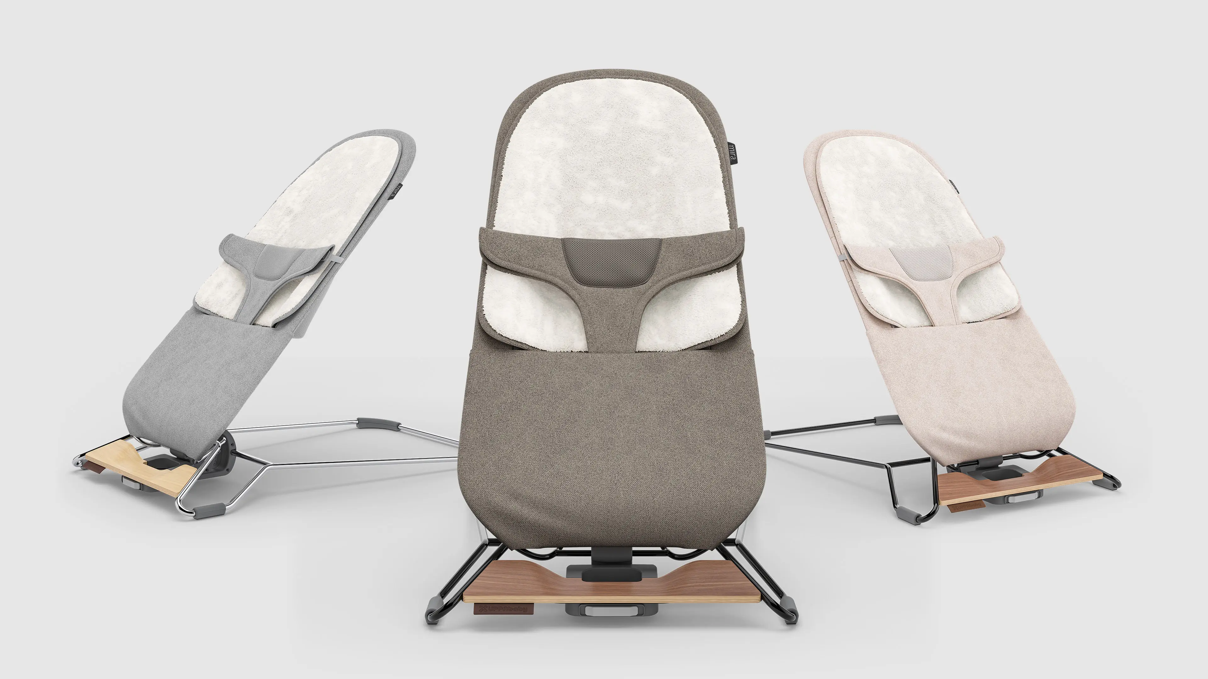 3D visualization of baby bouncers in three fabric colors with ergonomic design and wood-accented metal frames