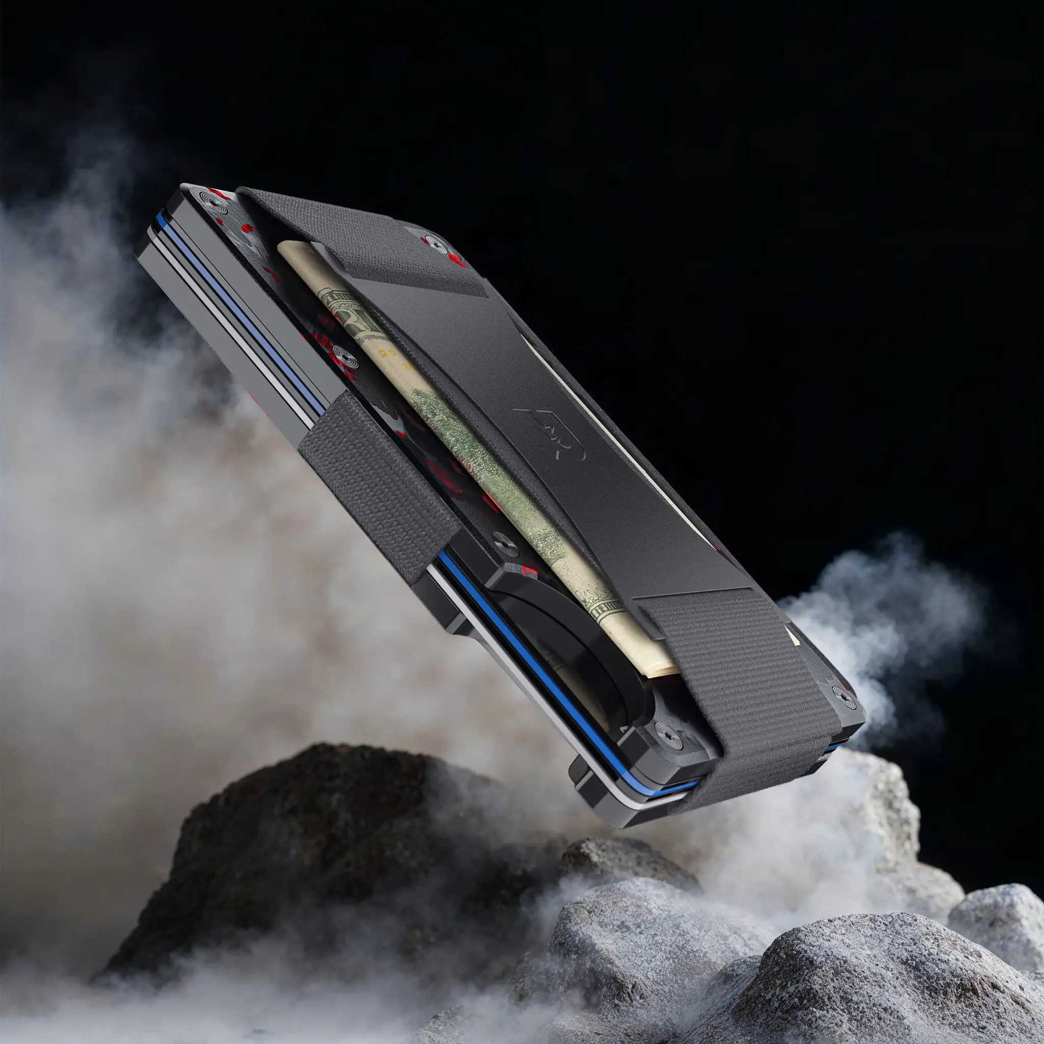 3D product visualization of a rugged tactical wallet displayed above rocky terrain with smoke effects.
