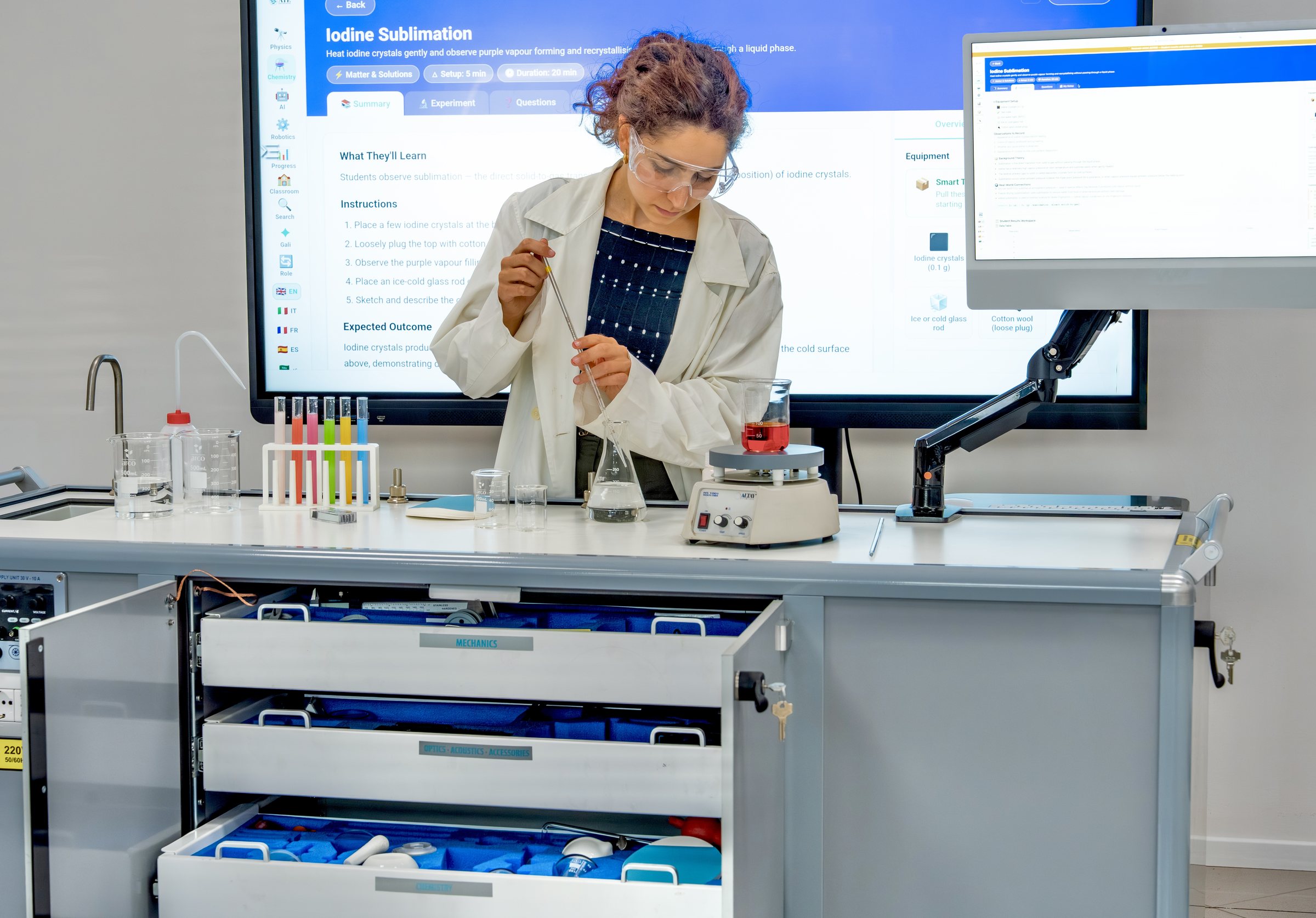 A teacher working at the ATP Mobile Lab with the experiment shown on the screen behind