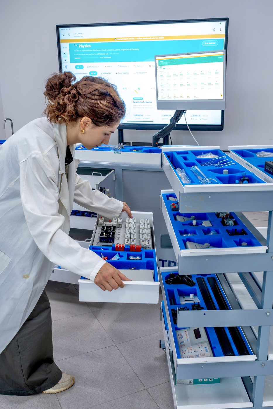 A teacher opening the equipment drawers of an ATP mobile lab