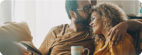 Man kissing woman on head