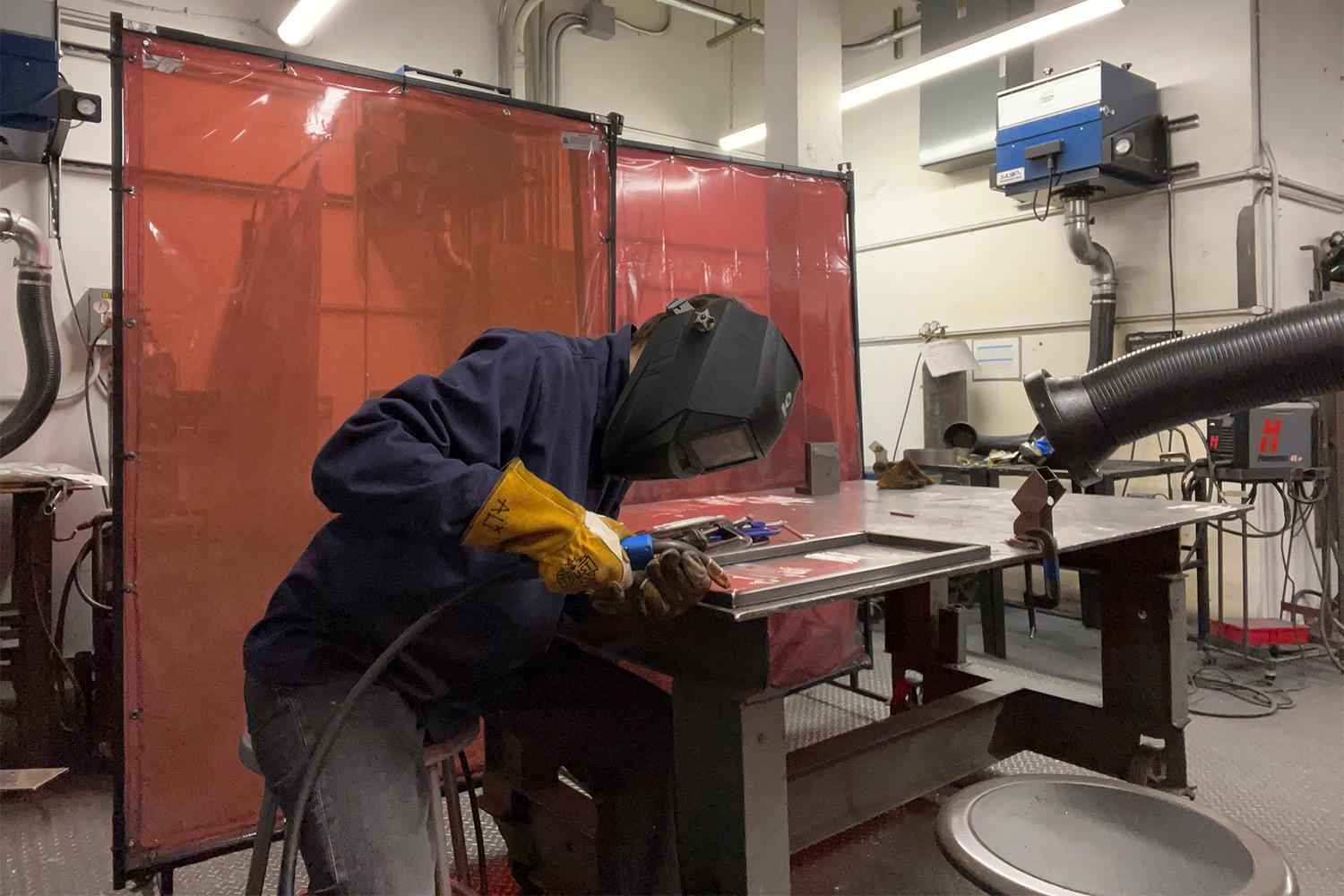 Photograph of me welding in a metal shop.