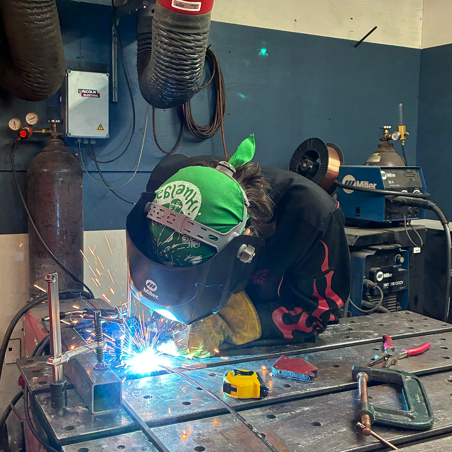 Photograph of me welding metal rods together to form the helix. 
