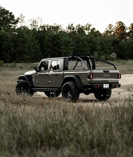Lifted Jeep Gladiator in a field, Adrenaline Offroad Co. build