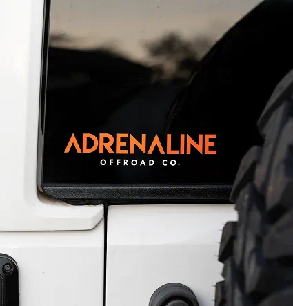 Adrenaline Offroad Co. orange decal on a Jeep window