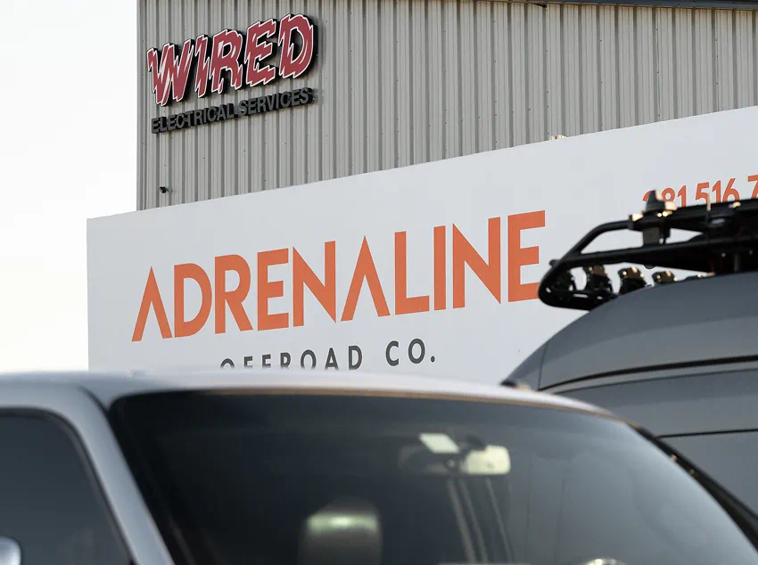 Adrenaline Offroad Co. sign on the shop exterior, seen from the road