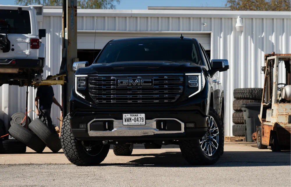 Lifted GMC Sierra Denali at the shop, front view