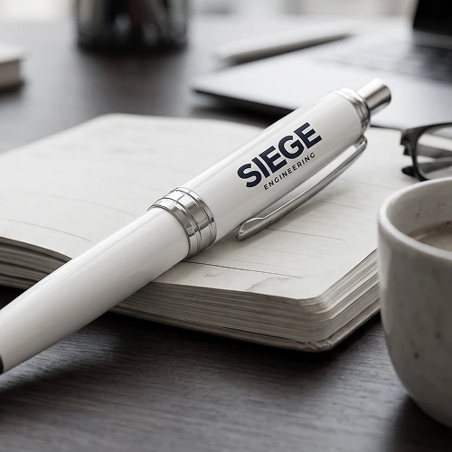 Siege Engineering branded pen on a notebook.