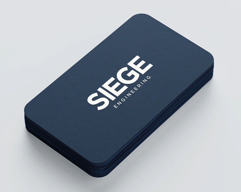 Stack of navy Siege Engineering business cards.