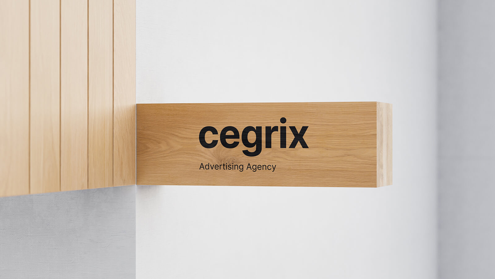Cegrix Advertising Agency logo displayed on a modern wooden wall-mounted sign against a white wall background.