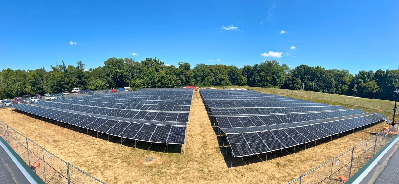 Workers installing Planted Solar’s high-density, terrain-following solar arrays on a space-constrained project site in Illinois