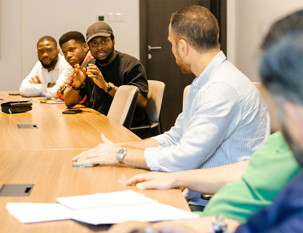  A group of men discusses ideas around a business table