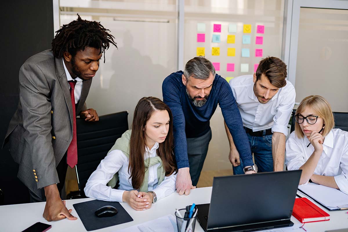 A team looking at a laptop