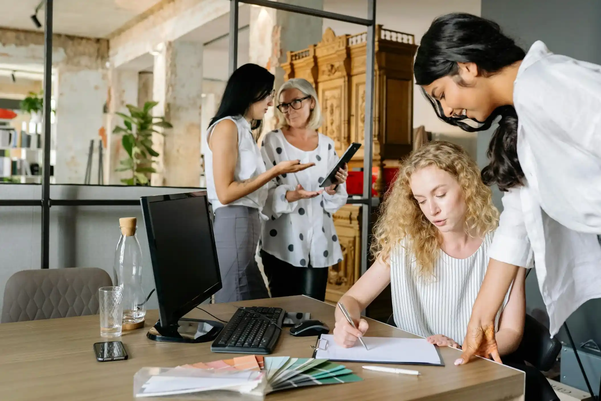 women having discussion in office