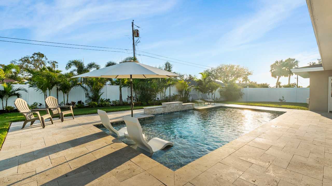 backyard swimming pool with sun rays