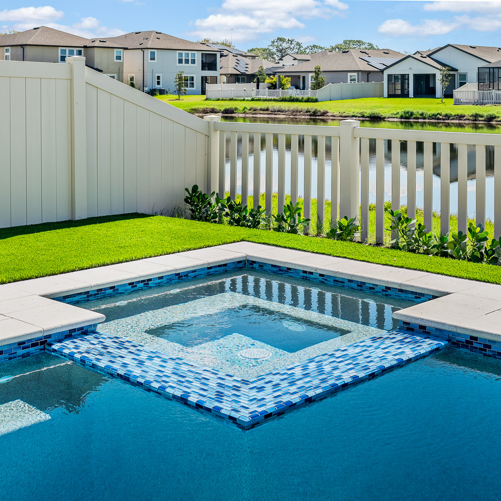A beautifully integrated spa that appears to be flush with the water