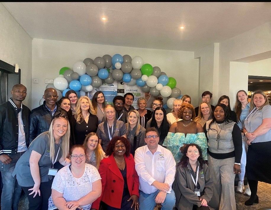 Care team celebrating CQC Good rating with digital care management