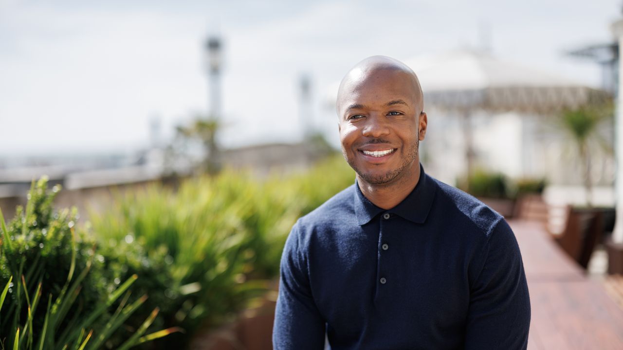 Undray Griffith, founder of One Root Mortgages, smiling on a terrace