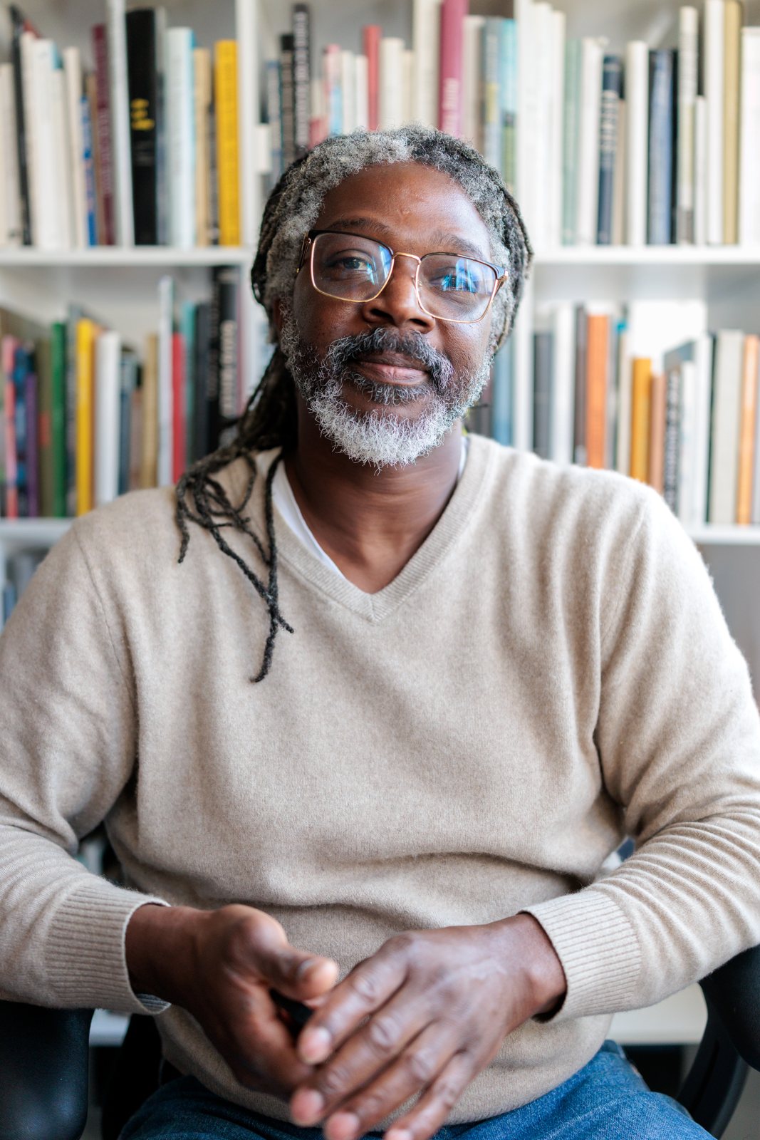 Kevan Smith, founder of Epiphany Content, sitting in front of his bookshelf