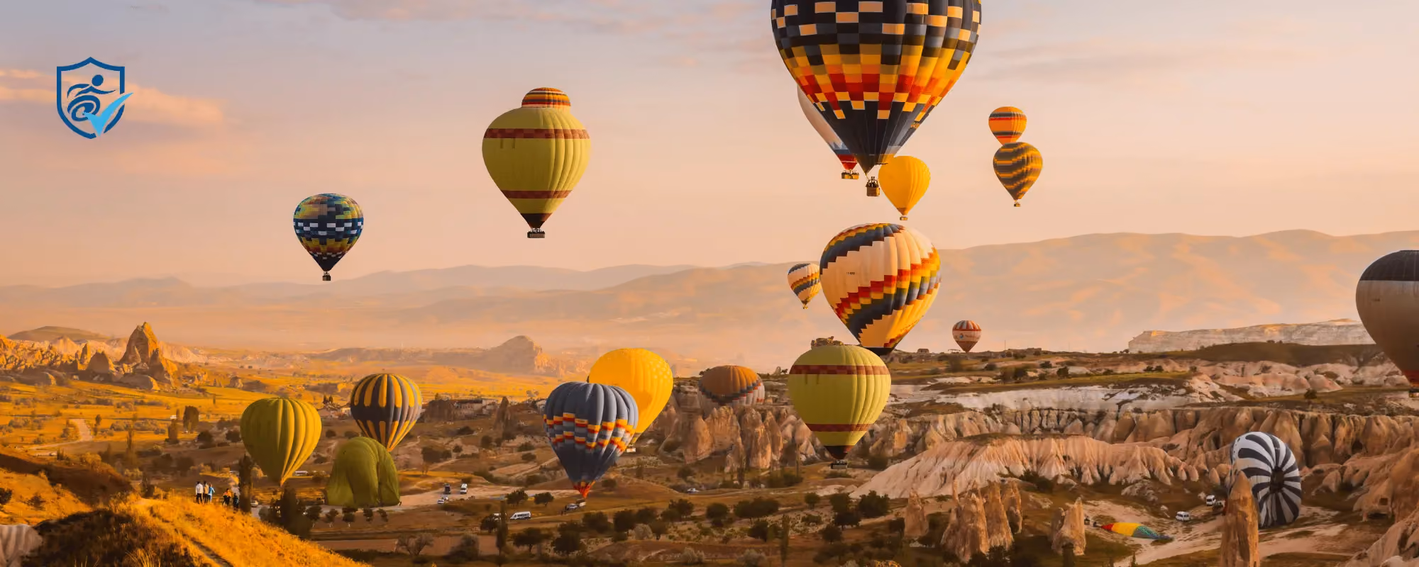 Photo of hot air balloons over a valley in turkey.