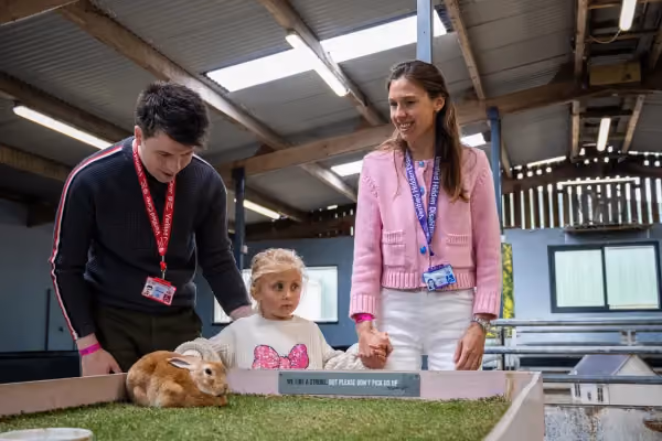 Man with a National Carers Card and woman with a National Disability Card and a child at a farm park
