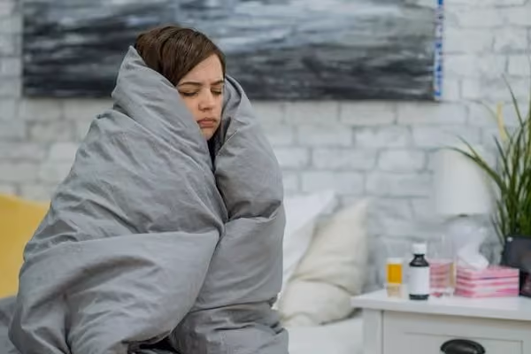 Person keeping warm with a duvet.