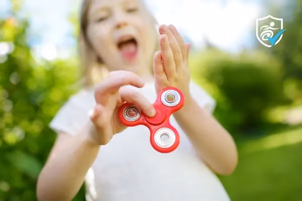 Child carrying a red sensory friendly fidget toy