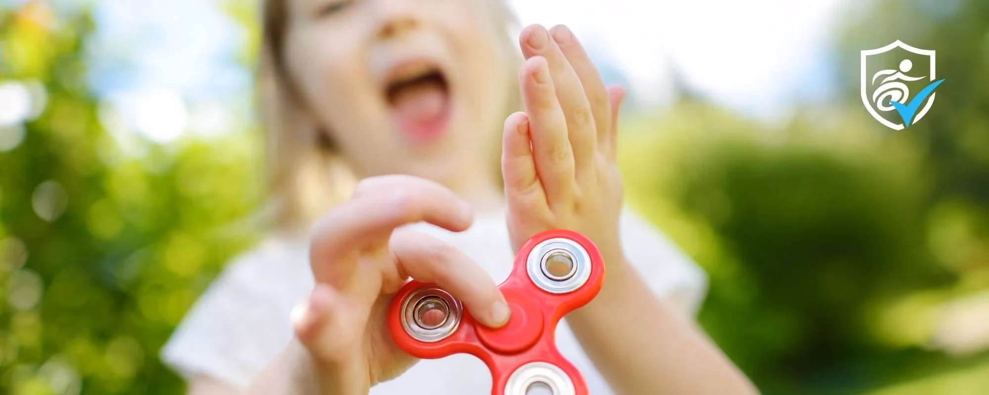 Girl holding a red fidget toy