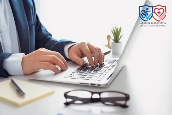 Person working on laptop at a desk with glasses