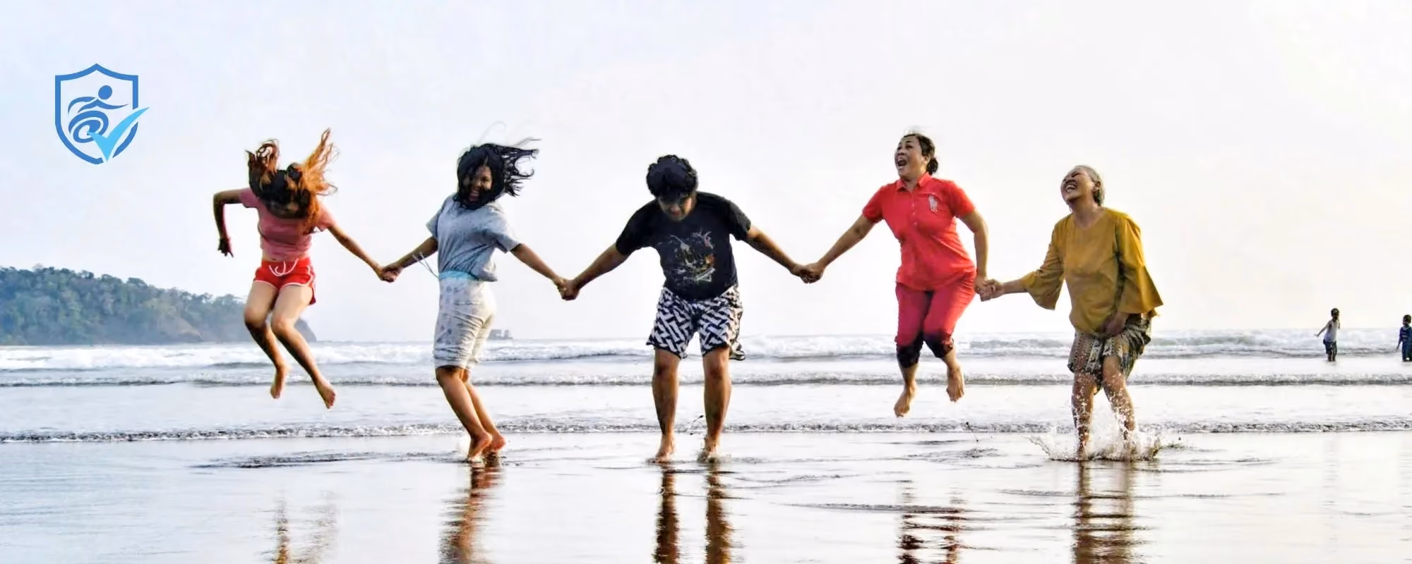 Autism friends holding hands and jumping on a beach