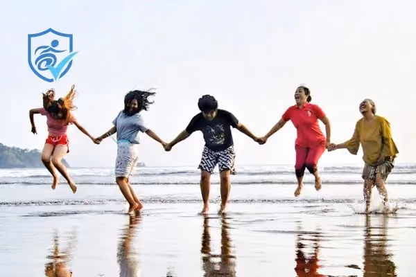 Autism friends holding hands and jumping on a beach