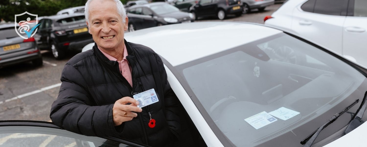 Photo of a man getting into his car with a blue badge in the dashboard. He is holding his National Disability Card