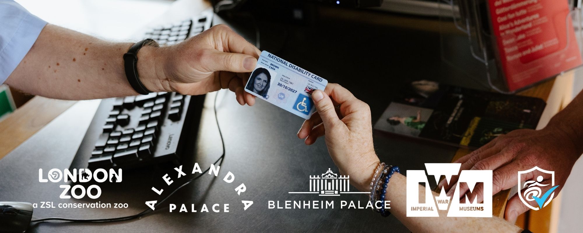 close-up photo of someone handing over their National Disability Card at a ticket kiosk