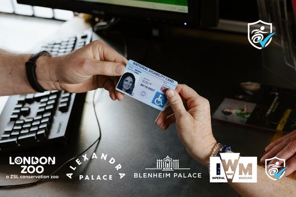 close-up photo of someone handing over their National Disability Card at a ticket kiosk