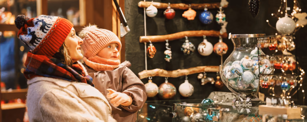Photo of a woman and a child in woollen hats in a Christmas shop